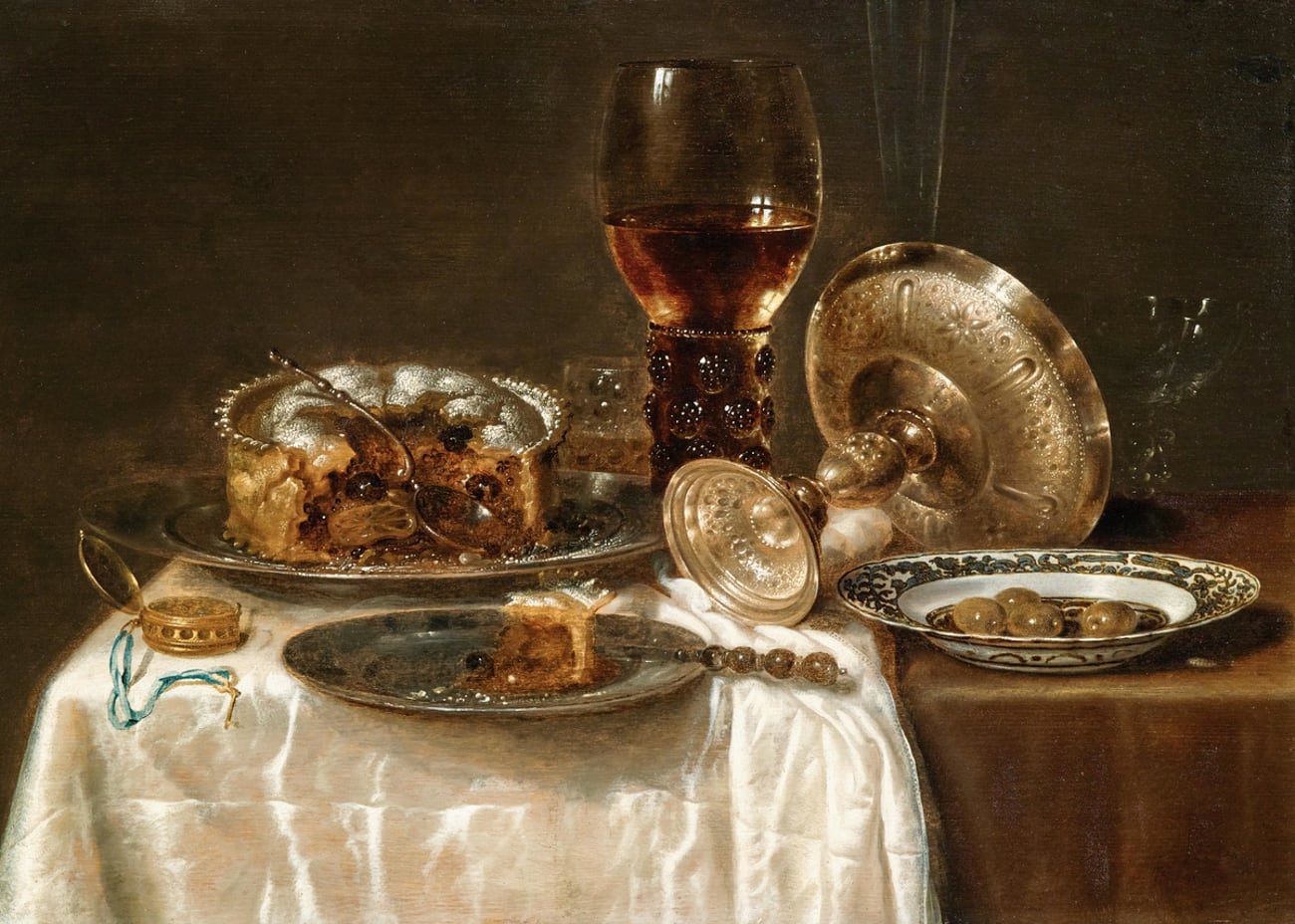 Olives in a Blue and White Porcelain Bowl, a Roemer, Wine Glasses, an Overturned Silver Tazza and a Meat-Pie
